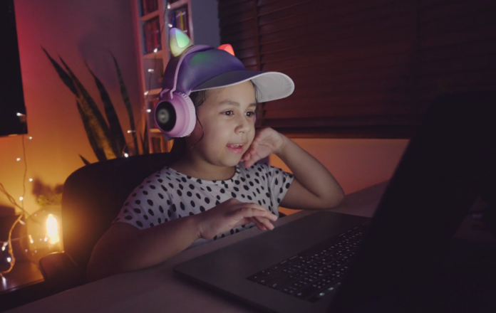 girl playing game on laptop